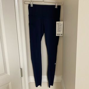 Lululemon Fast and Free 25 inch tight. BNWT size 4.Navy with side pockets.